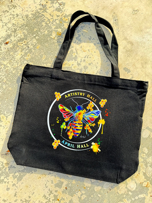 Black tote bag with Honey Bee design with the name "Artistry Hall" & artist "April Hall"