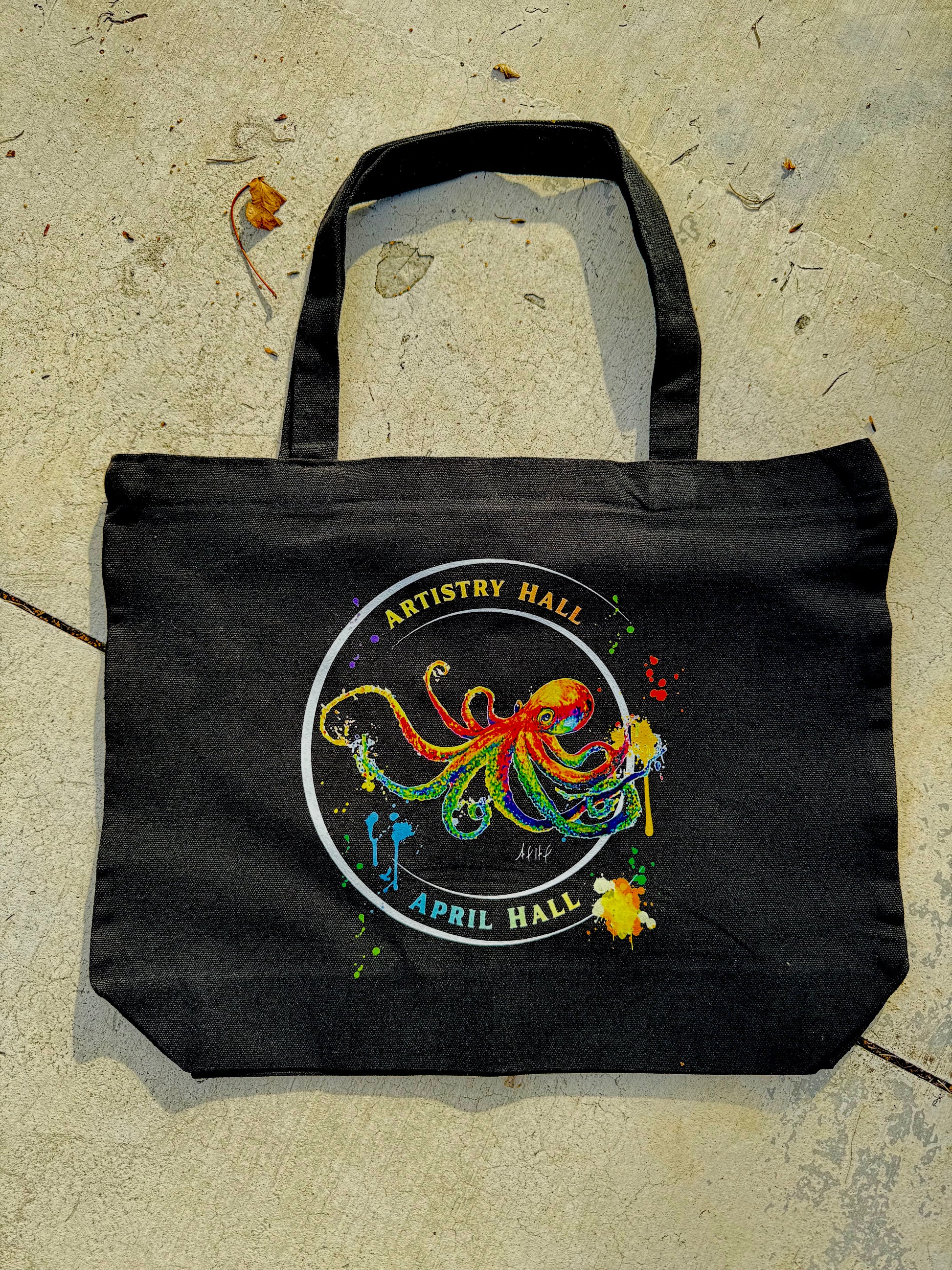 Black tote bag with a colorful octopus design.