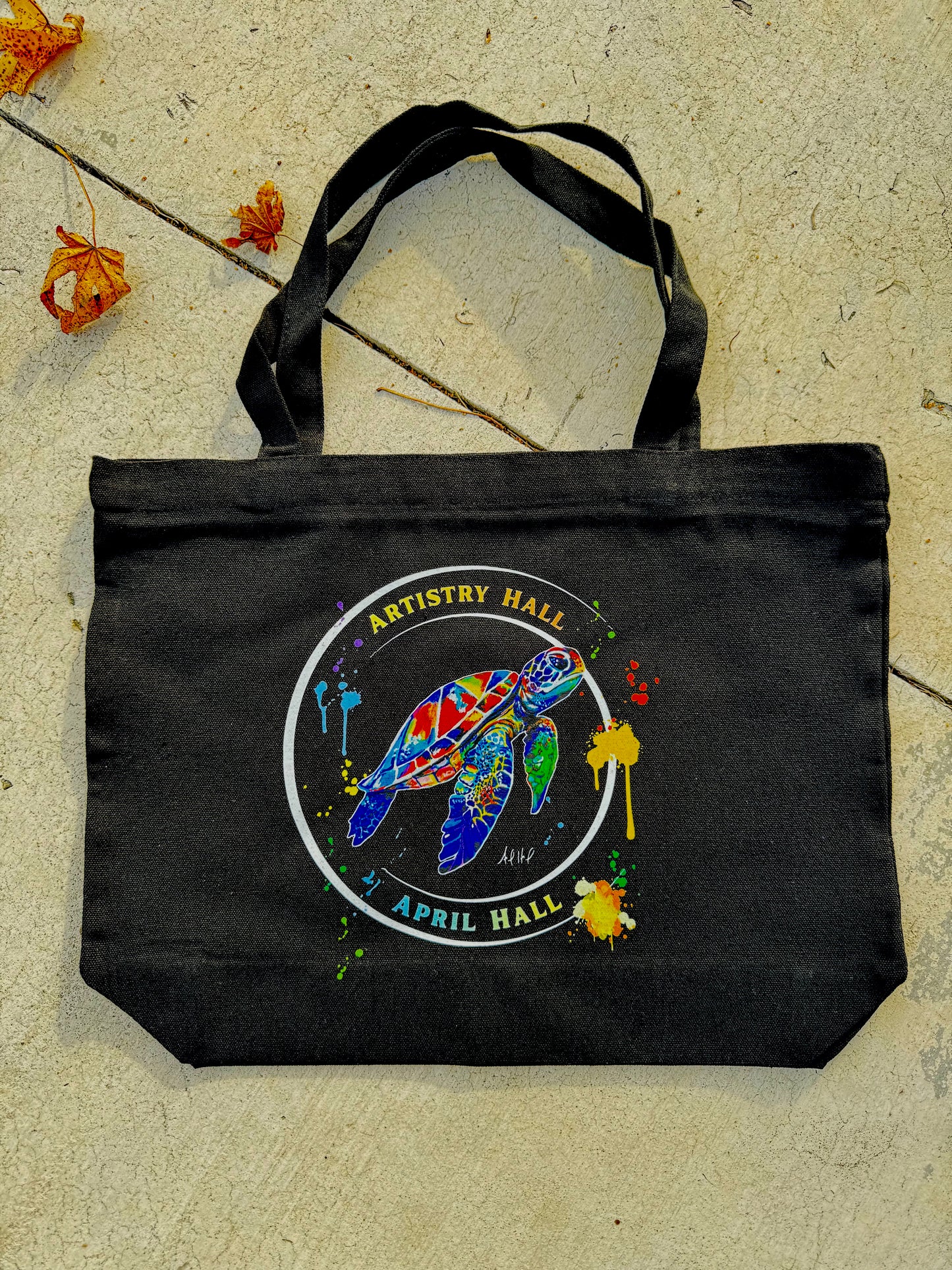 Black tote bag with Turtle design with the name "Artistry Hall" & artist "April Hall"